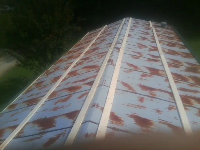 Rusted metal roof panels with new wood purlins before replacement — Storm Damage Roof Repair in Middleville by Roofing Brothers